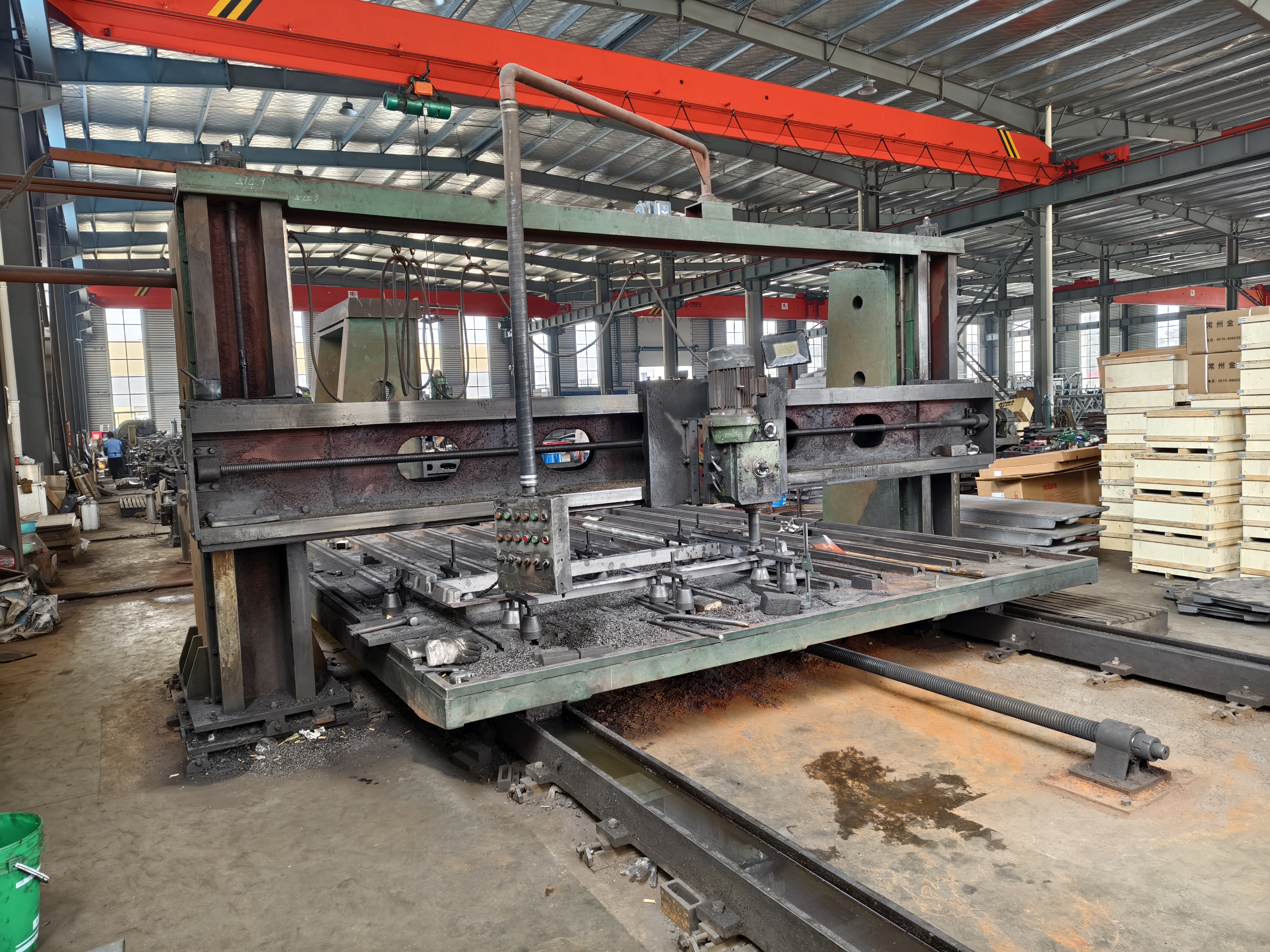 Large-format machining center processing a steel structural component in the workshop
