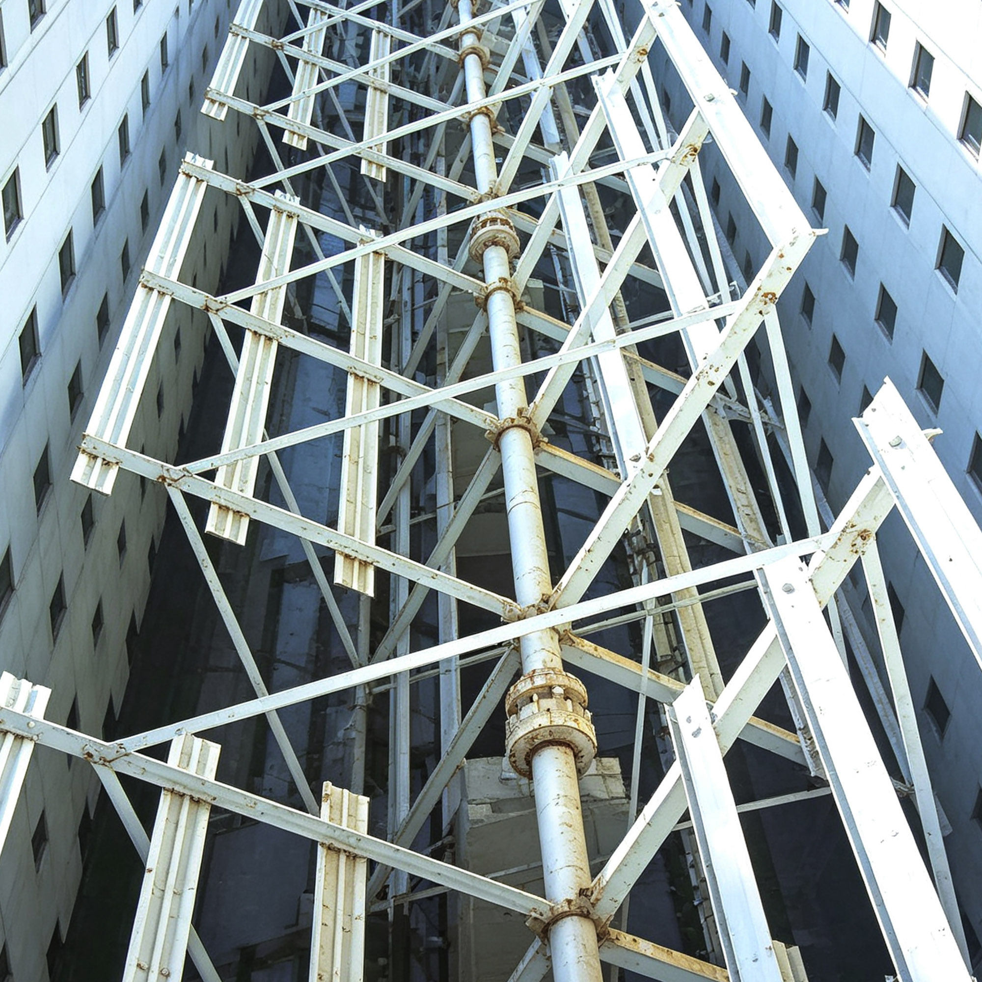 Steel structural frame assembly viewed from below inside the workshop
